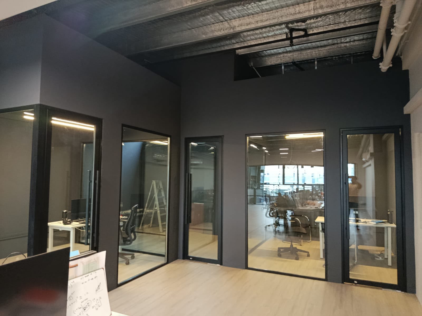 Glazed office partitions and exposed ceiling at FOMO Energy in Frontier Ubi