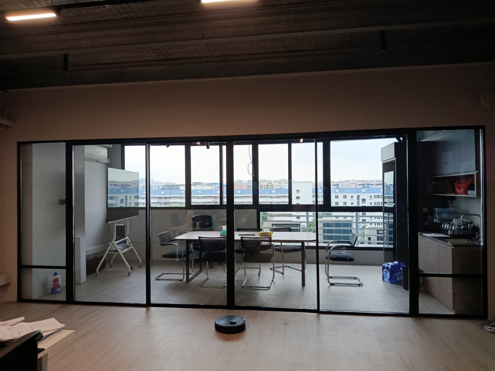 FOMO Energy pantry and meeting area with an industrial-style ceiling